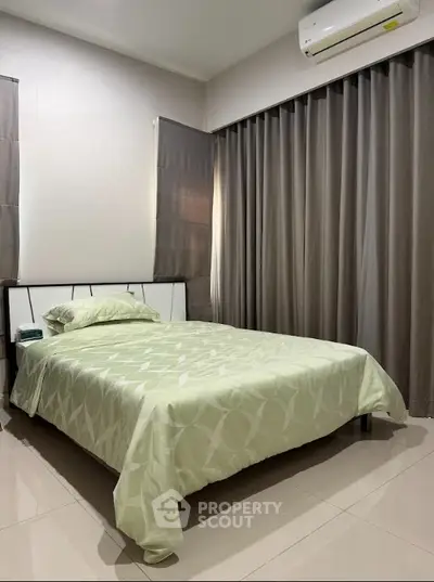 Cozy bedroom with modern design and air conditioning, featuring elegant curtains and tiled flooring.