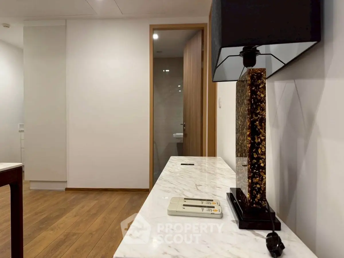 Modern interior with marble console and stylish lamp in a contemporary apartment.
