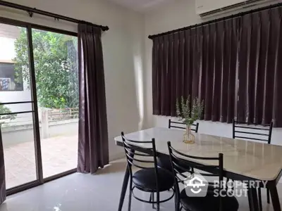 Bright dining area with large windows and modern furniture