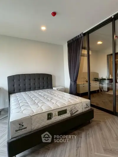 Modern bedroom with stylish decor and large glass sliding doors