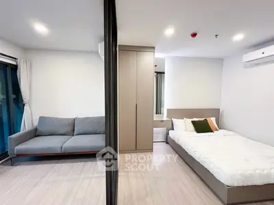 Modern studio apartment with cozy bed and stylish sofa