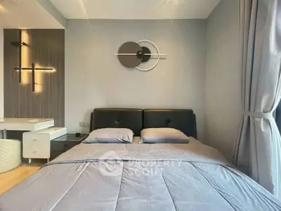 Modern bedroom with stylish decor and cozy bedding in a contemporary apartment.