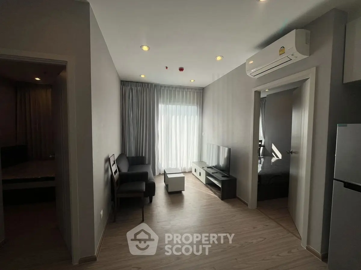 Modern living room with sleek furniture and natural light in a stylish apartment.
