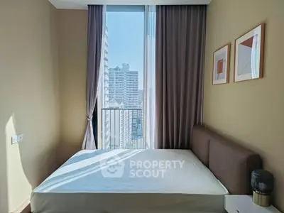 Modern bedroom with large window and city view, featuring stylish decor and natural light.