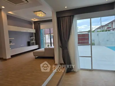 Spacious living room with pool view and modern decor