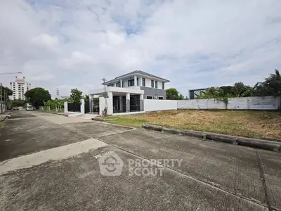 Modern two-story house with spacious yard in suburban neighborhood