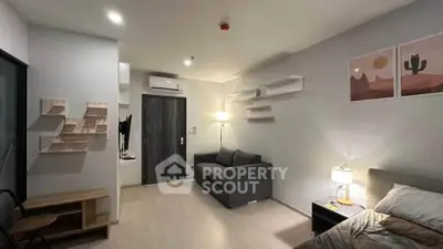 Modern living room with stylish decor and cozy ambiance, featuring a comfortable sofa and contemporary wall art.
