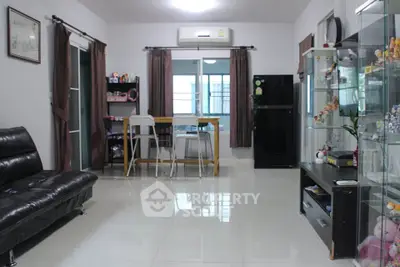 Spacious living room with modern furniture and large windows for natural light.