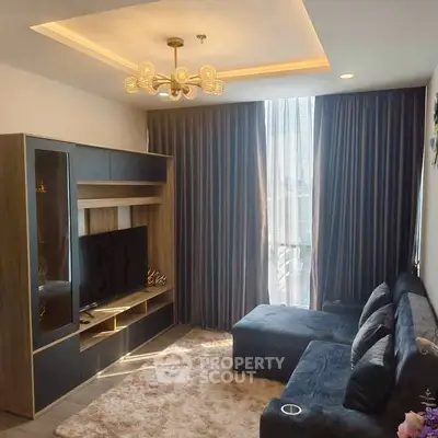 Modern living room with stylish furniture and large window, perfect for relaxation.