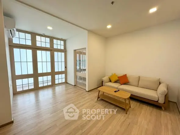 Spacious living room with modern decor and natural light