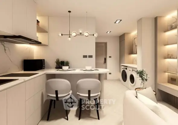 Modern kitchen with open layout, stylish lighting, and built-in appliances in a cozy apartment.