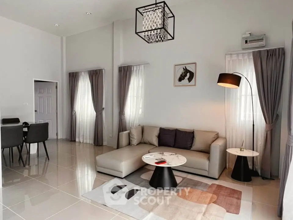 Modern living room with stylish decor and elegant dining area in open layout.