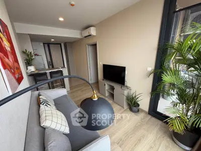 Modern living room with stylish decor and large window for natural light.