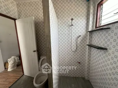 Modern bathroom with unique circular patterned tiles and open shower design