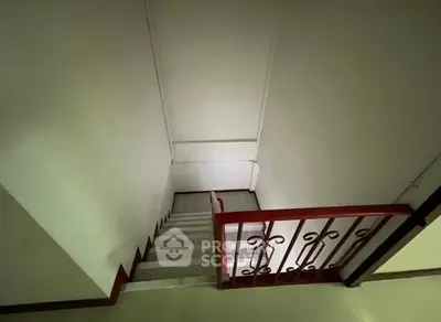 Spacious staircase with elegant railing in modern home interior