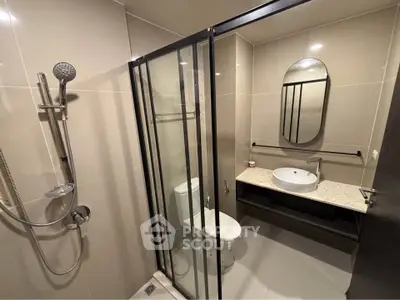 Modern bathroom with glass shower enclosure and sleek fixtures