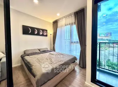 Modern bedroom with balcony and scenic view, featuring stylish decor and ample natural light.