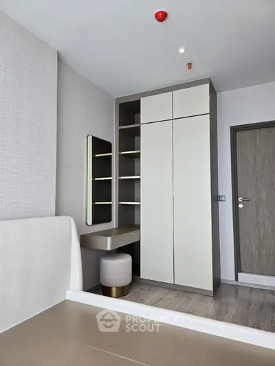Modern bedroom with sleek wardrobe and vanity area