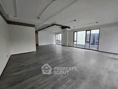 Spacious modern living room with large windows and sleek flooring