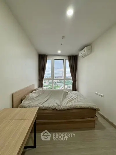 Modern bedroom with large window offering stunning city view, featuring minimalist decor and air conditioning.