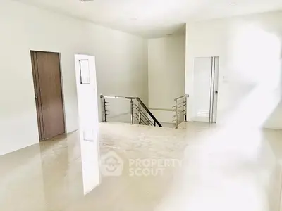 Spacious modern interior with sleek staircase and glossy tile flooring