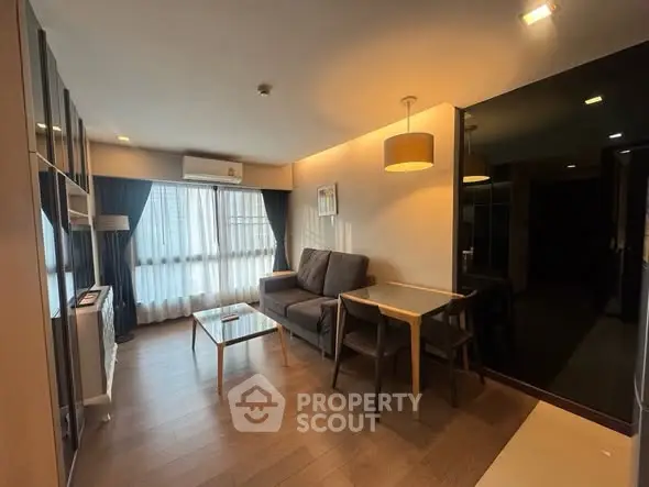 Modern living room with cozy sofa and stylish lighting in a chic apartment.