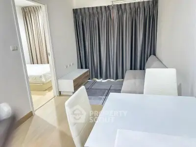 Modern apartment interior with cozy living room and adjacent bedroom, featuring stylish furniture and neutral tones.
