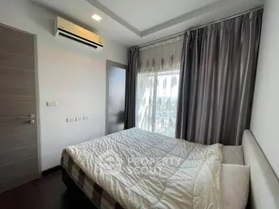 Cozy bedroom with modern air conditioning and large window with curtains
