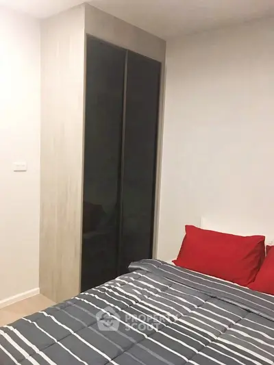 Cozy bedroom with modern wardrobe and stylish bedding