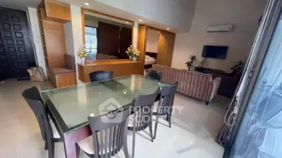 Spacious open-plan living and dining area with modern furnishings and natural light.
