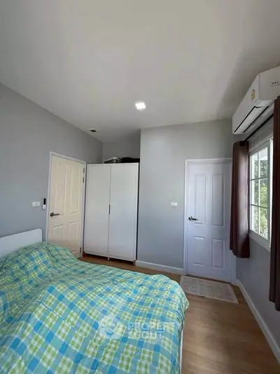 Cozy bedroom with modern decor and ample natural light