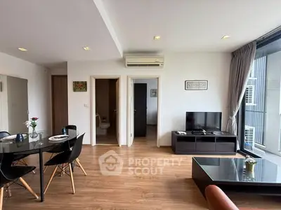 Spacious modern living room with wooden flooring and sleek furniture