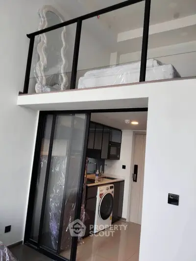 Modern loft apartment with mezzanine bedroom and compact kitchen