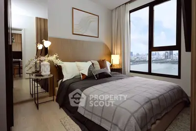 Modern bedroom with large window offering stunning city and river views.