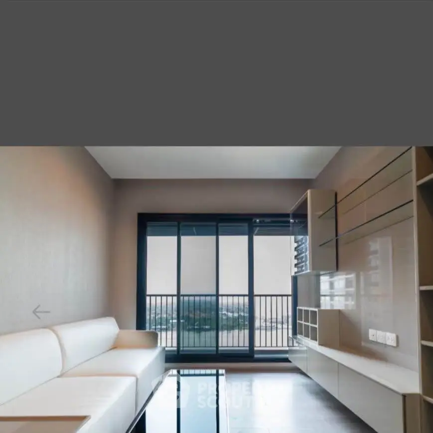 Modern living room with sleek furniture and large windows offering a stunning view.