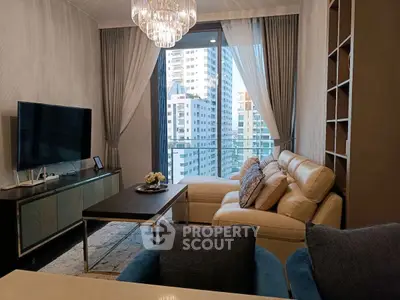 Luxurious living room with modern decor and city view from balcony.