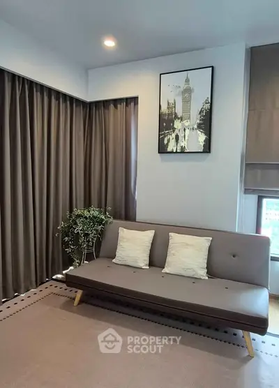 Modern living room with stylish sofa, elegant curtains, and chic wall art, perfect for urban living.