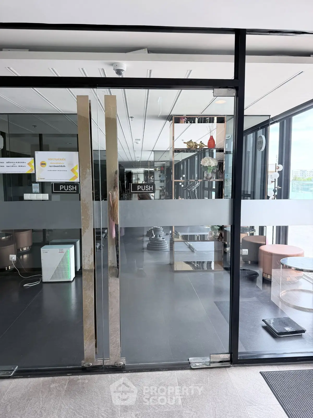 Modern gym entrance with glass doors and sleek interior design