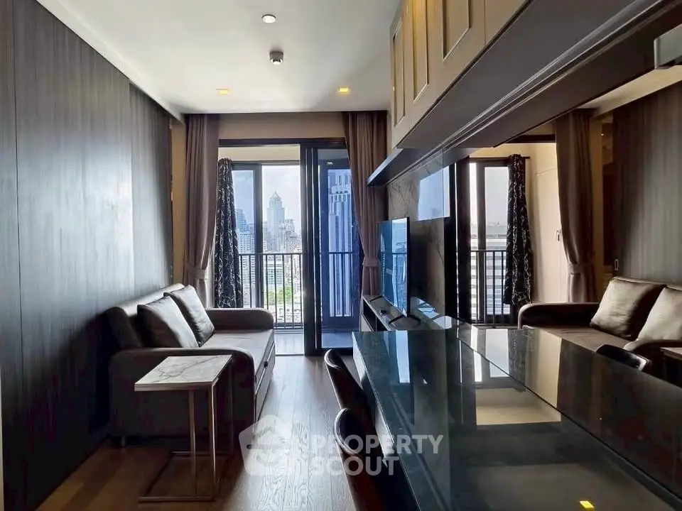 Modern living room with city view, sleek furniture, and floor-to-ceiling windows in a high-rise apartment.