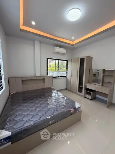 Modern bedroom with sleek furniture and ambient lighting, featuring a comfortable bed and ample storage space.