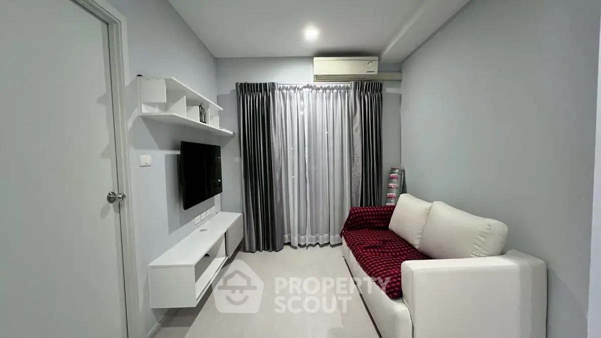 Modern living room with sleek furniture and wall-mounted TV