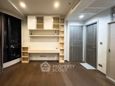Modern interior with built-in shelves and wooden flooring, ideal for a stylish living space.