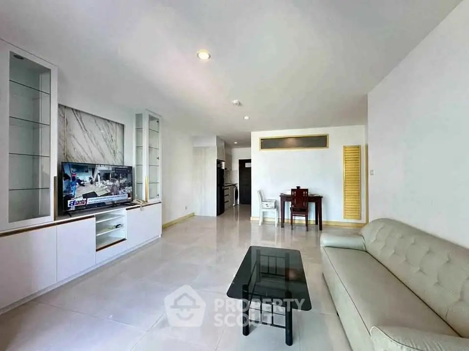 Spacious modern living room with sleek furniture and open layout, perfect for relaxation and entertainment.