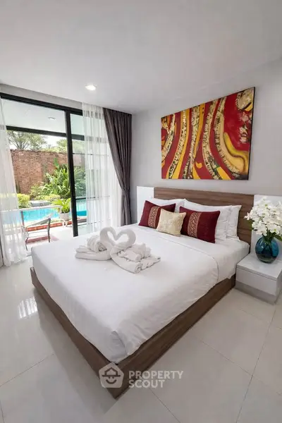 Luxurious bedroom with pool view and elegant decor in modern real estate property.