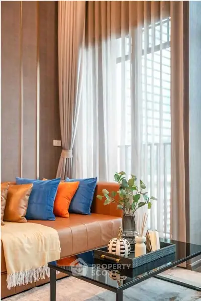 Stylish living room with modern decor and large windows offering natural light.