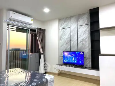 Modern living room with balcony view and stylish TV setup in a high-rise apartment.