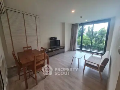 Spacious living room with balcony view and modern furniture