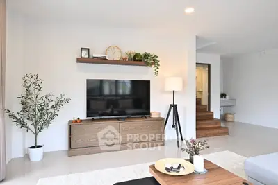 Modern living room with sleek TV stand, wooden accents, and stylish decor