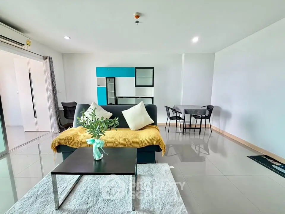 Spacious modern living room with sleek furniture and bright decor in a contemporary apartment.