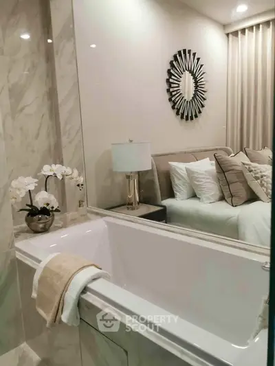 Luxurious bathroom with elegant decor and a cozy bedroom view, perfect for relaxation and comfort.
